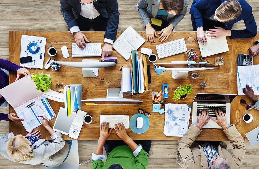 A business team working together with AI tools
